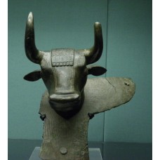 Bronze winged bull's heads from handles of a large cauldron
